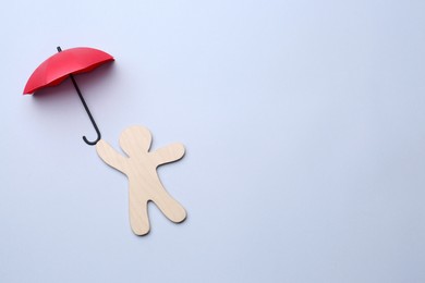 Photo of Mini umbrella and human figure on white background, top view. Space for text
