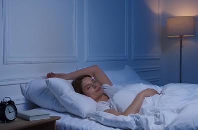 Photo of Beautiful woman sleeping in bed at night