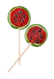 Photo of Watermelon shaped lollipops on sticks against white background, top view