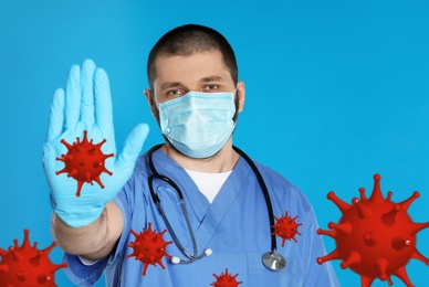 Image of Stop Covid-19 outbreak. Doctor wearing medical mask surrounded by virus on blue background