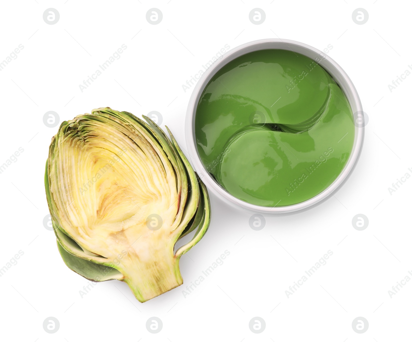 Photo of Package of under eye patches and artichoke on white background, top view. Cosmetic product