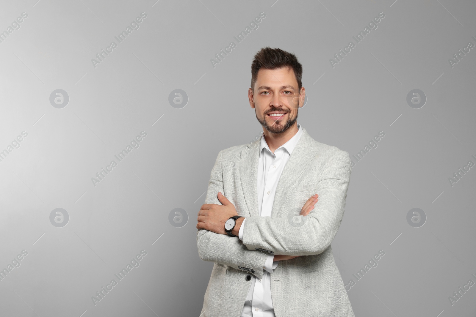 Photo of Happy teacher in light suit against beige background