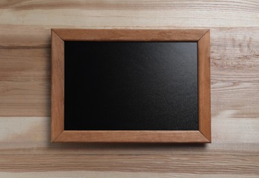 Photo of Blank chalkboard on wooden background, top view. Space for text