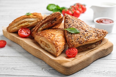 Fresh delicious puff pastry served on white wooden table