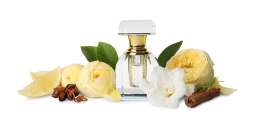 Photo of Bottle of perfume, lemon, flowers and spices on white background