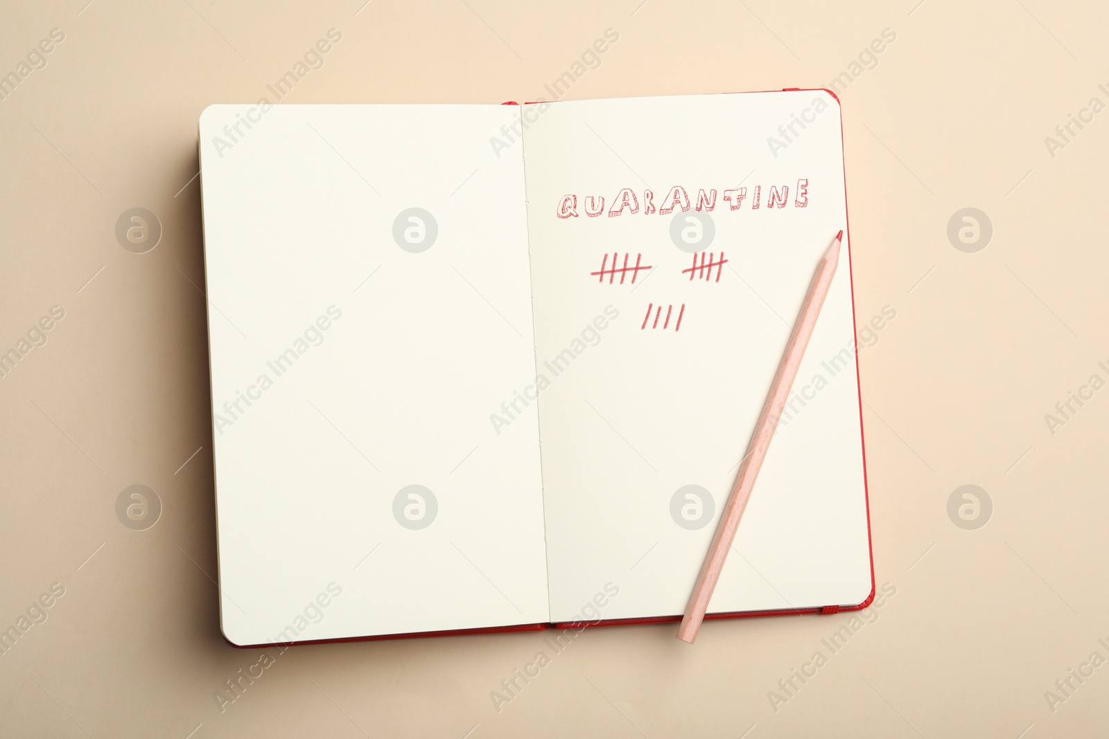 Image of Open notebook and pencil on beige background, top view. Counting days of quarantine during coronavirus outbreak