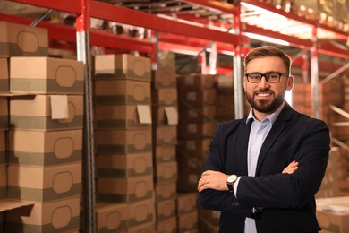 Image of Manager near stacked boxes at warehouse. Logistic center
