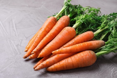 Photo of Bunch of fresh carrots on stone background