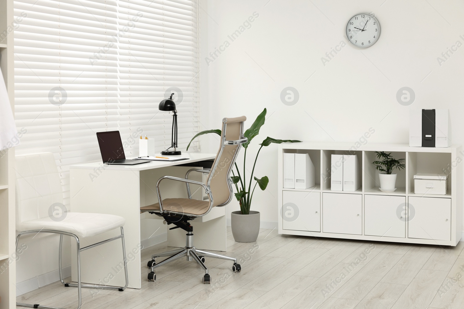 Photo of Doctor's workplace. Chairs and laptop on table in clinic