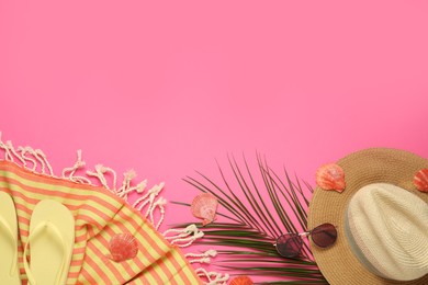 Flat lay composition with different beach objects on pink background, space for text