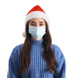 Beautiful woman wearing Santa Claus hat and medical mask on white background