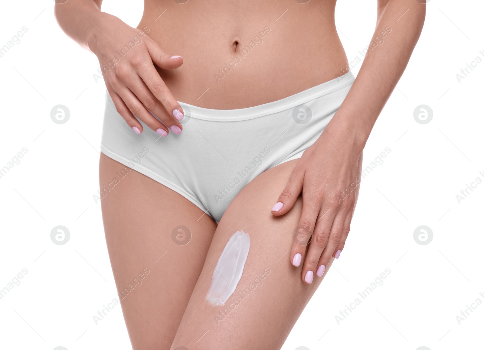 Photo of Woman with smear of body cream on her leg against white background, closeup