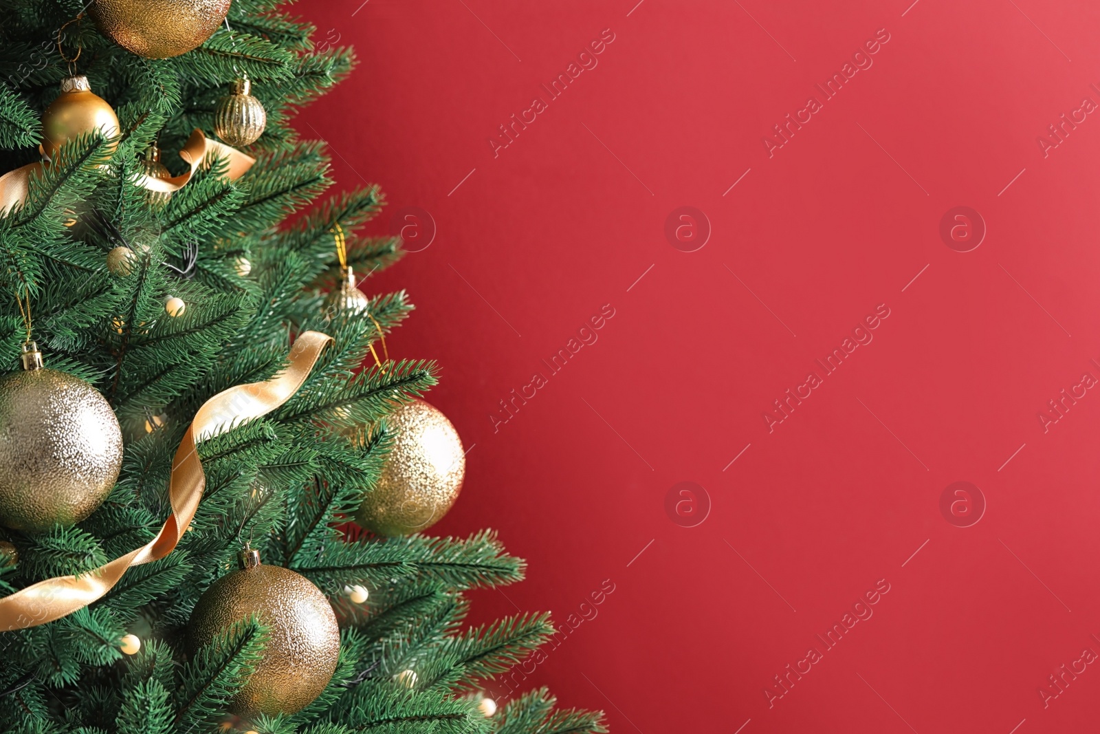 Photo of Beautiful Christmas tree with decor on red background. Space for text