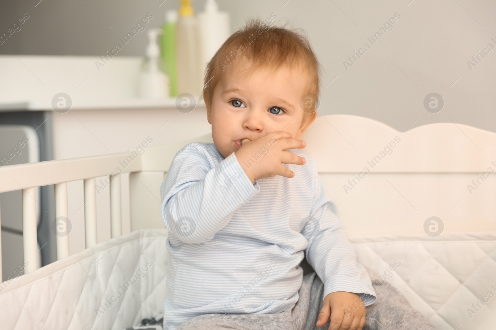 Photo of Cute little baby in crib at home