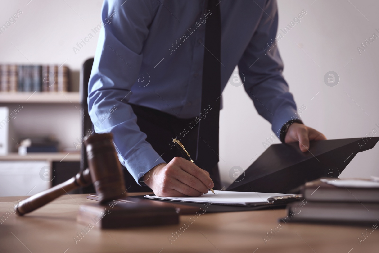 Photo of Male lawyer working at table in office, closeup