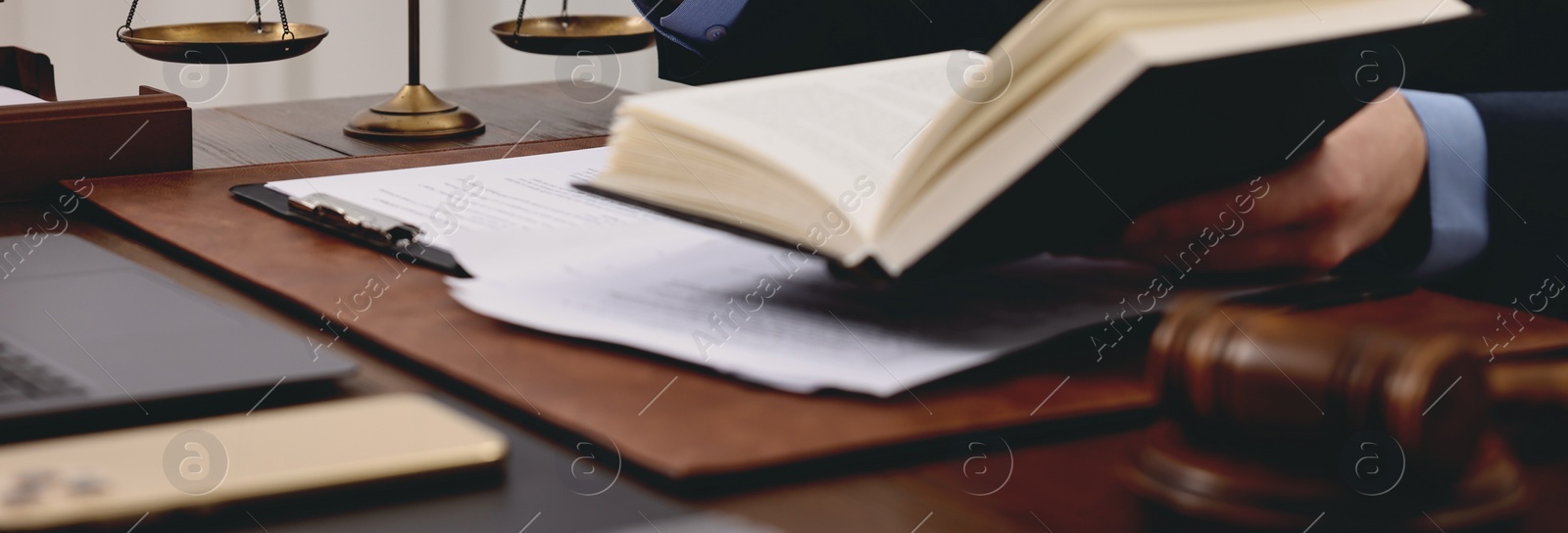 Image of Lawyer working with documents at wooden table in office, closeup. Banner design