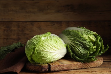 Photo of Fresh ripe Chinese cabbages on wooden table