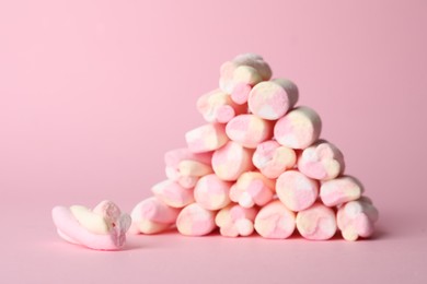 Stack of tasty marshmallows on pink background