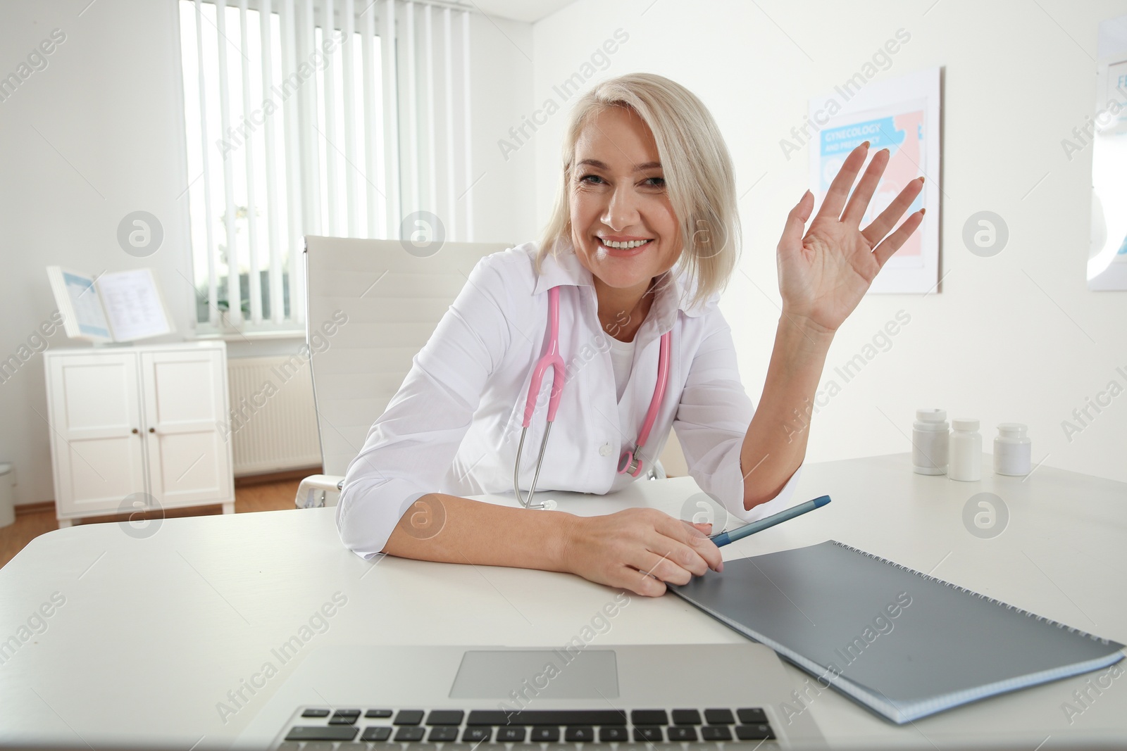 Photo of Doctor consulting patient using video chat in clinic, view from web camera