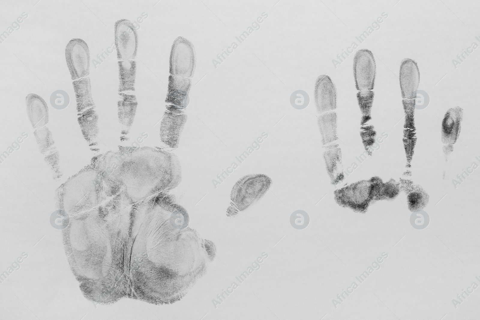 Photo of Print of hands and fingers on white background, top view. Criminal investigation