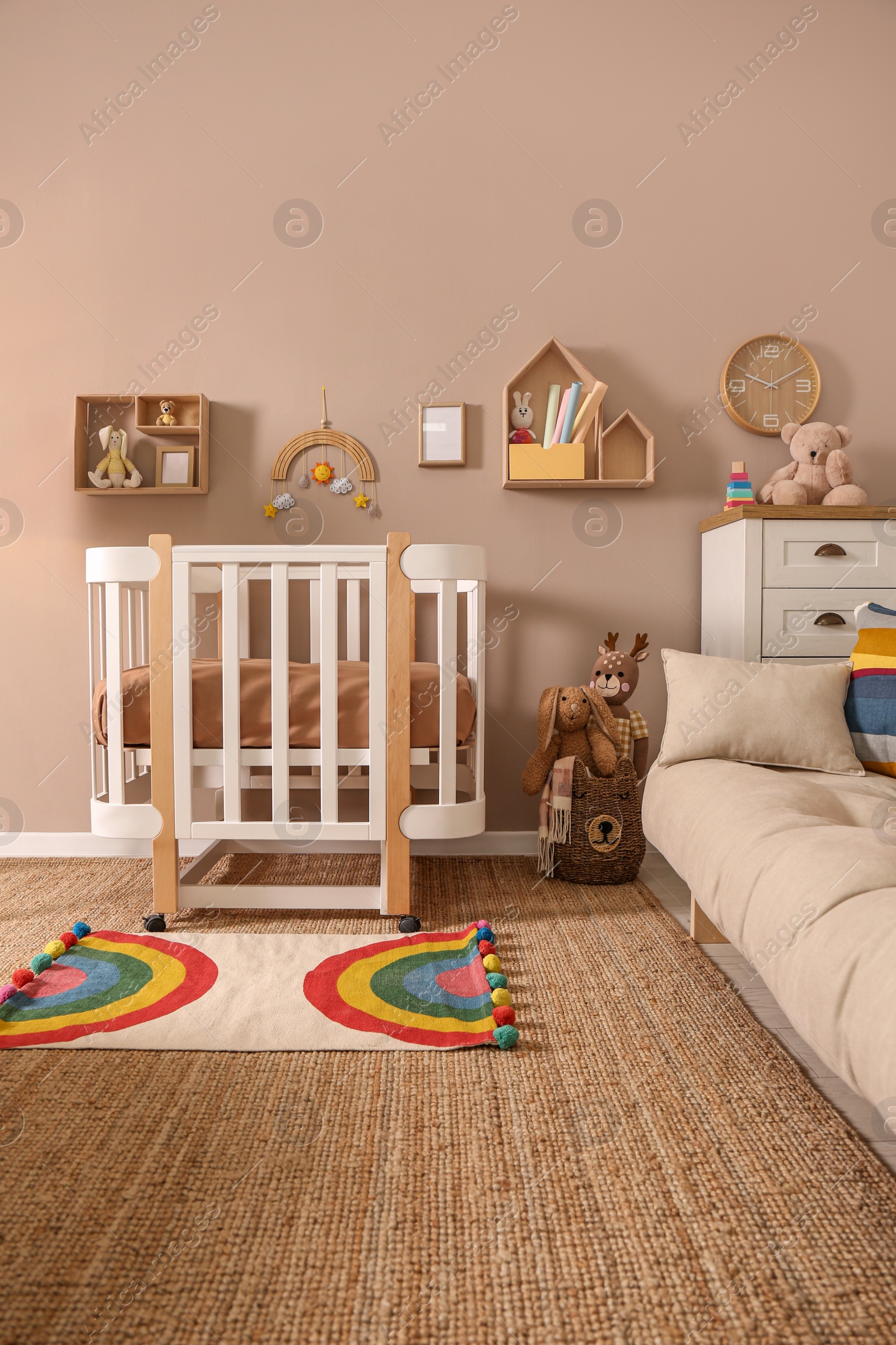 Photo of Baby room interior with stylish furniture and comfortable crib