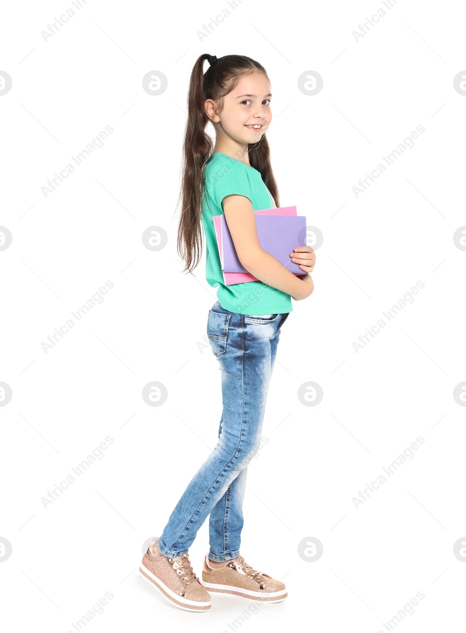 Photo of Little child with school supplies on white background