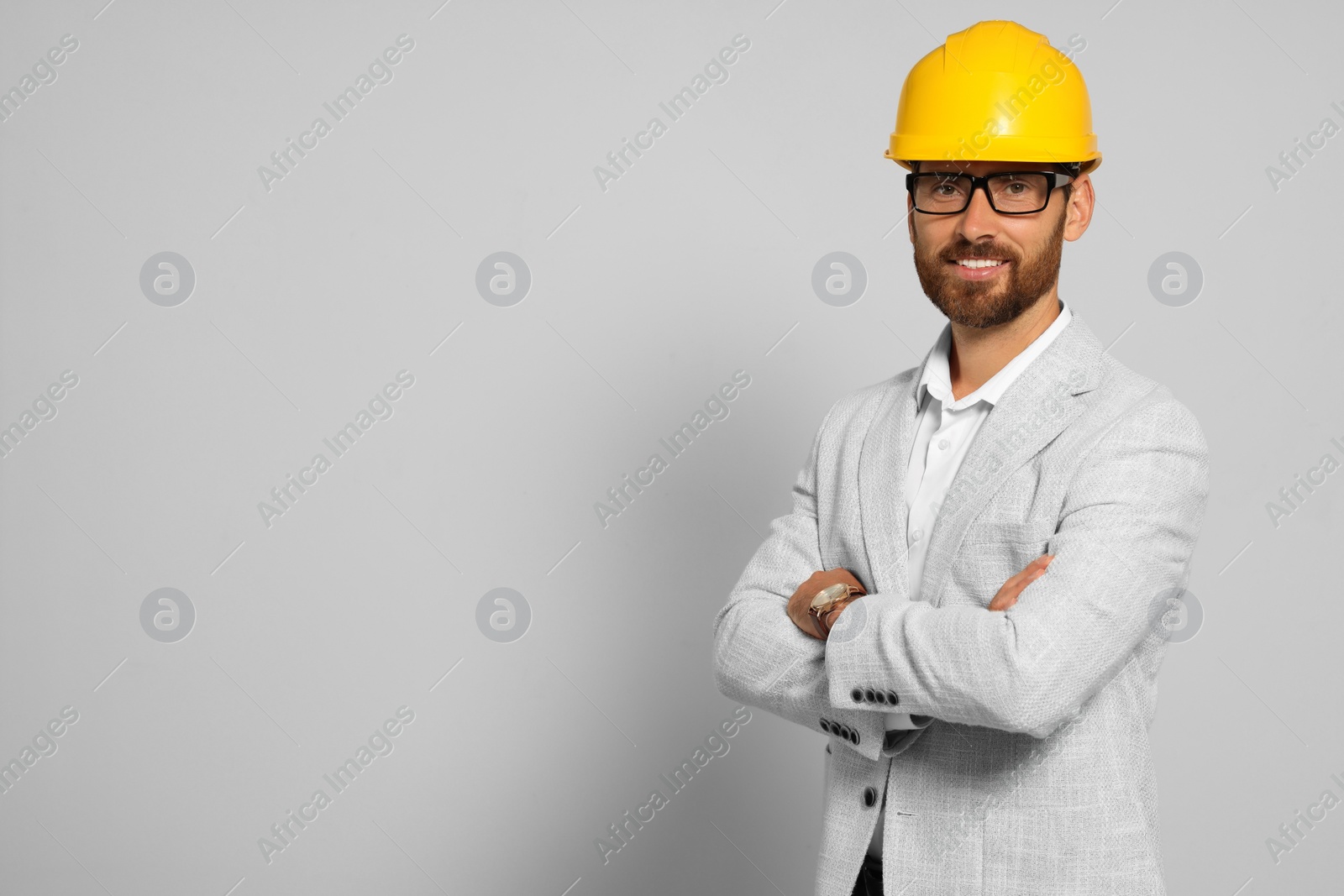 Photo of Professional engineer in hard hat on white background, space for text