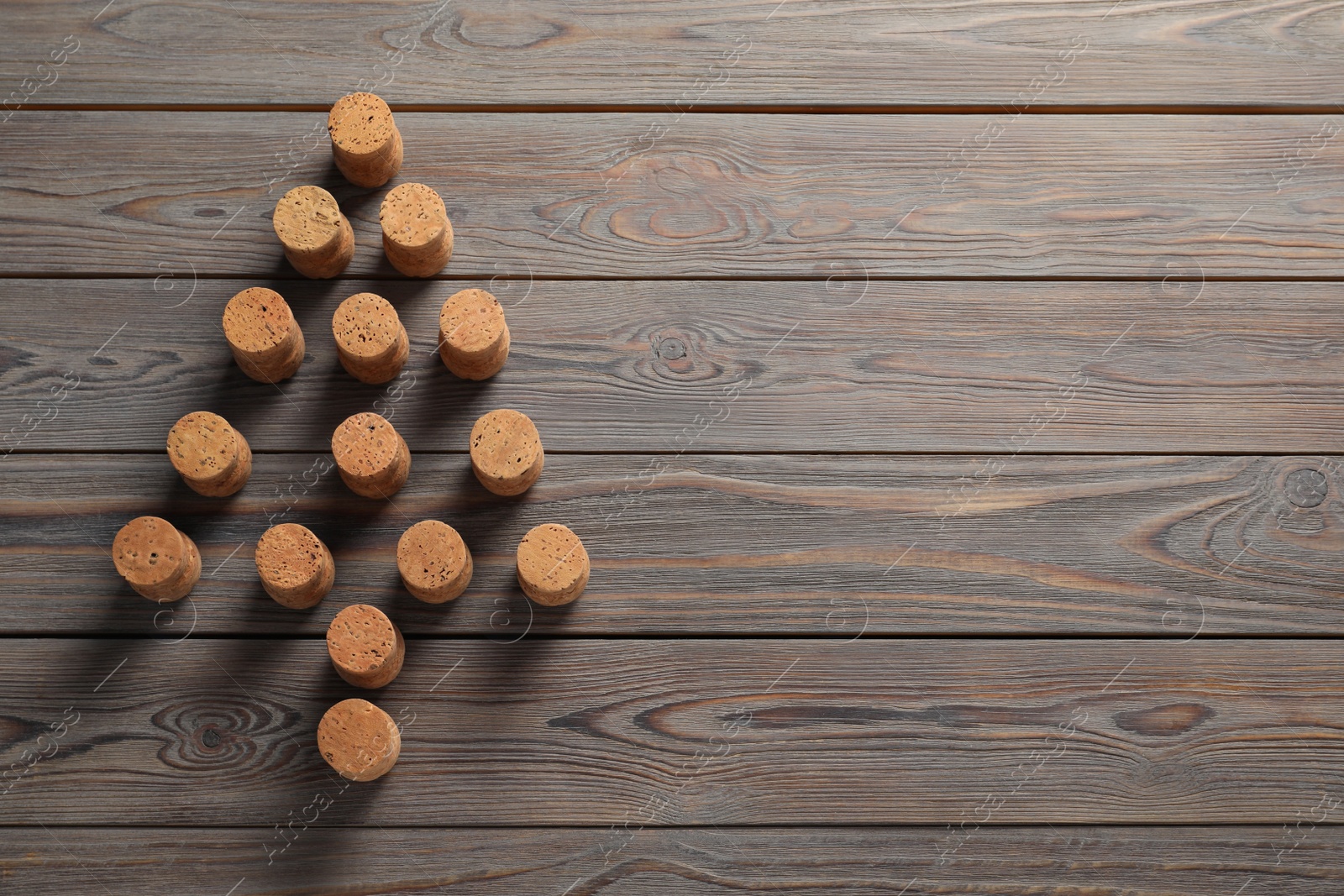 Photo of Christmas tree made of wine corks on wooden table, top view. Space for text