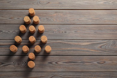 Christmas tree made of wine corks on wooden table, top view. Space for text