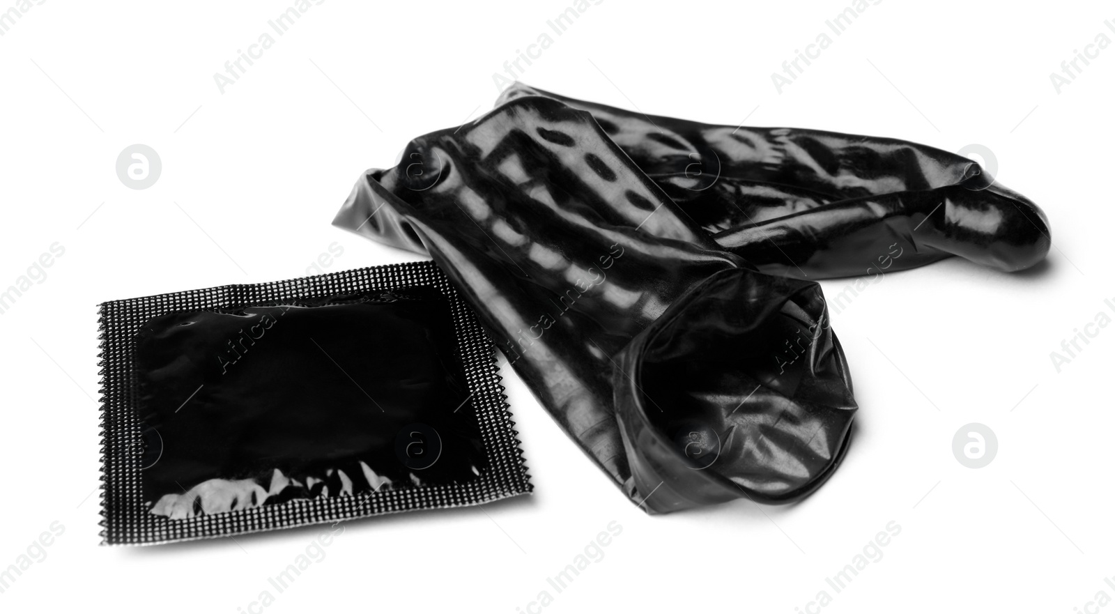 Image of Unrolled black condom and package on white background. Safe sex