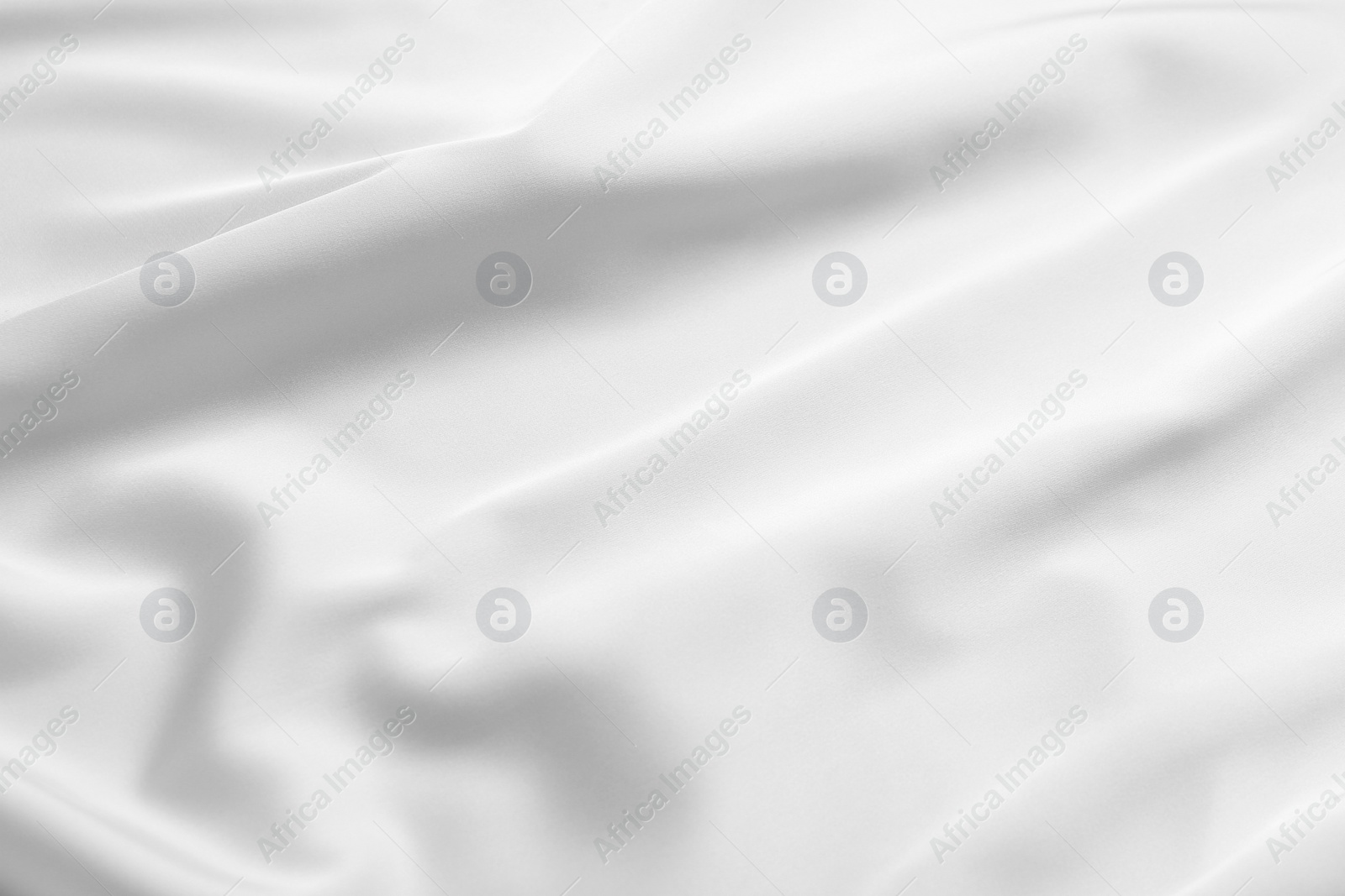 Photo of Texture of white silk ripple fabric as background, top view