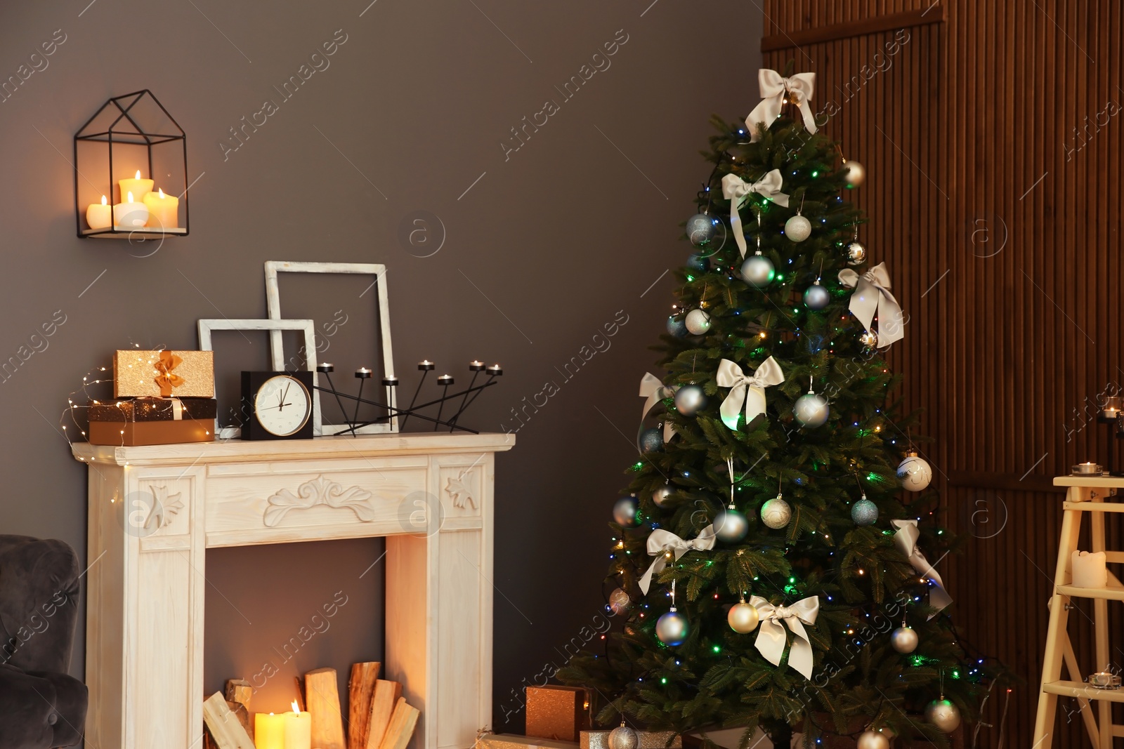 Photo of Stylish room interior with Christmas tree and decorative fireplace