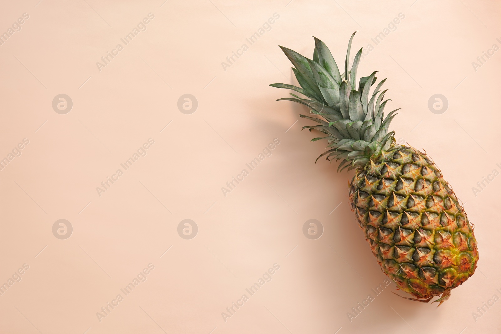 Photo of Fresh ripe pineapple on color background, top view