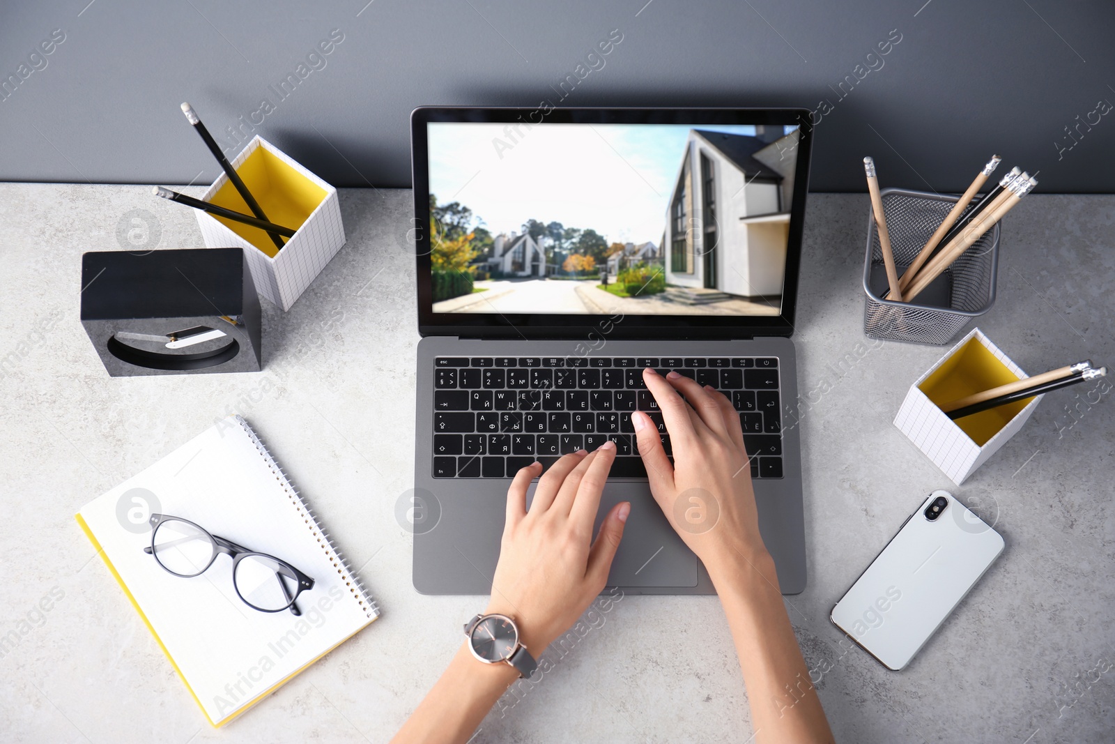 Image of Businesswoman or real estate agent looking through online property portfolio, top view