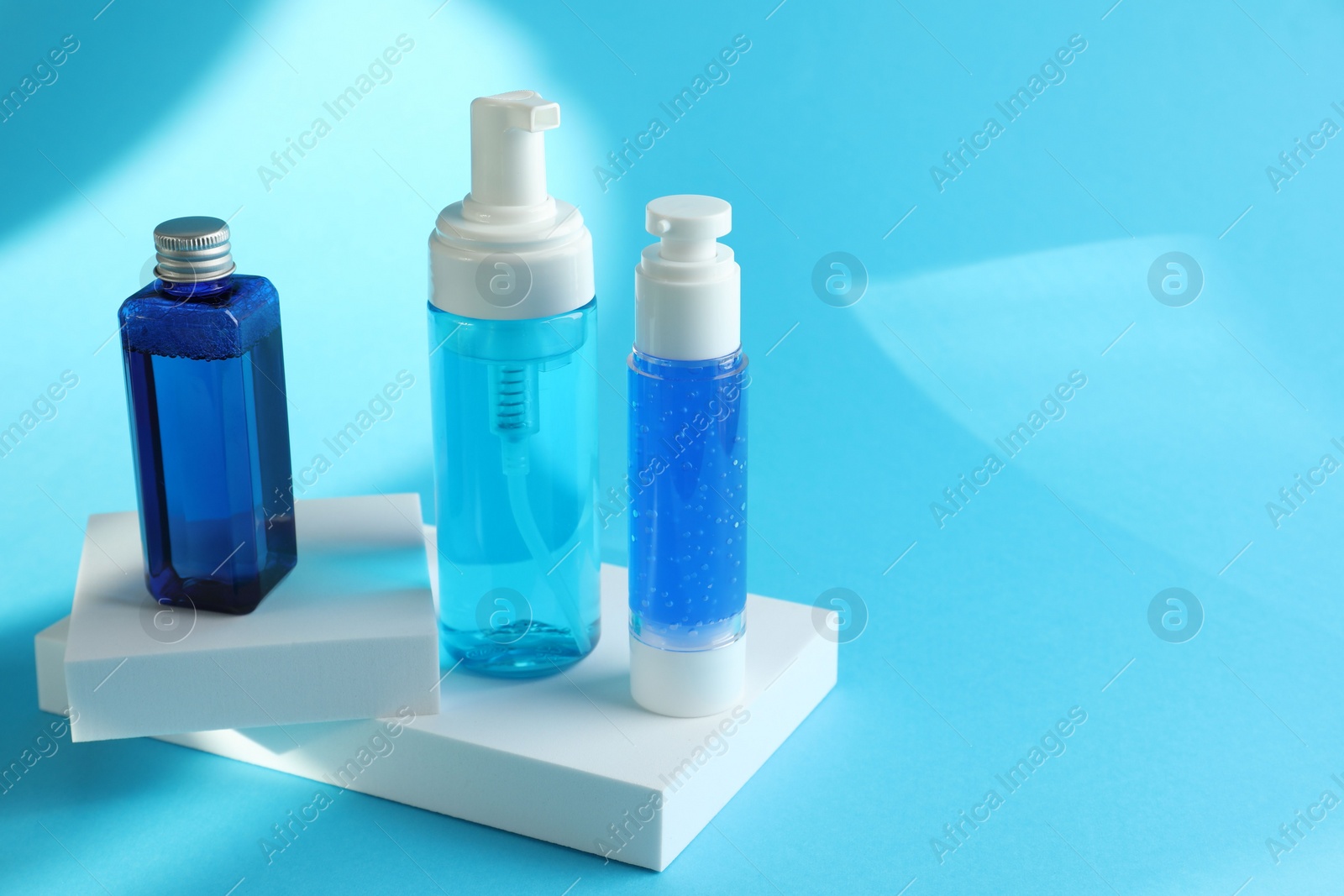 Photo of Set of luxury cosmetic products on light blue background. Space for text