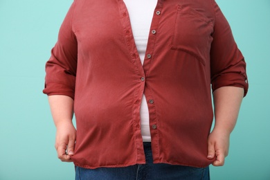 Overweight woman on color background