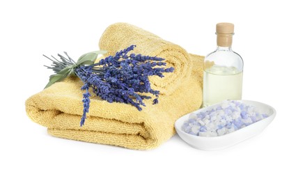 Photo of Spa composition. Towels, essential oil, sea salt and lavender flowers on white background