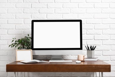 Photo of Cozy workspace with modern computer on wooden desk