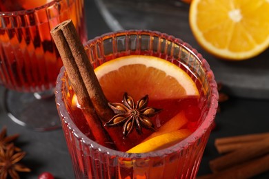 Photo of Glass with aromatic punch drink on table, closeup view