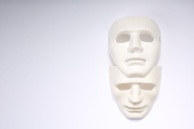 Photo of Theater arts. Two masks on white background, top view. Space for text