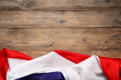 Photo of Flag of France on wooden background, top view. Space for text