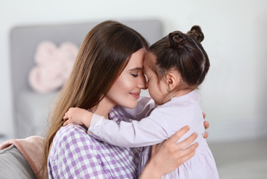 Young mother with little daughter at home