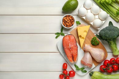 Photo of Flat lay composition with different fresh products on white wooden table, space for text. Keto diet