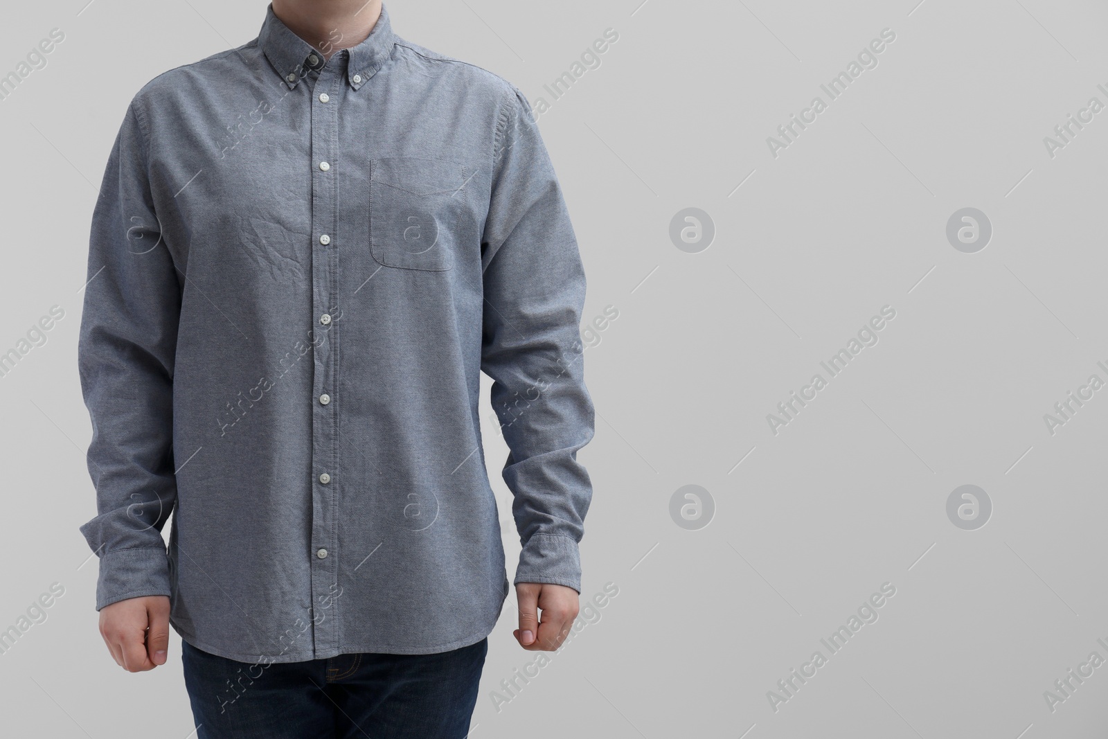 Photo of Man wearing clean shirt on white background, closeup. Space for text