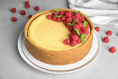 Photo of Dessert plate with delicious raspberry cake on grey table