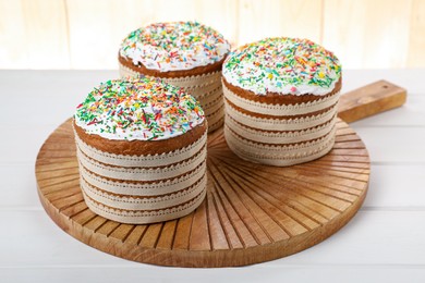 Traditional Easter cakes with sprinkles on white wooden table
