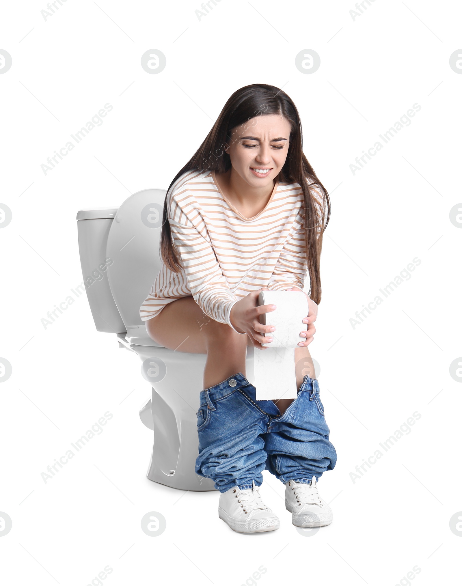 Photo of Woman with stomach ache sitting on toilet bowl, white background