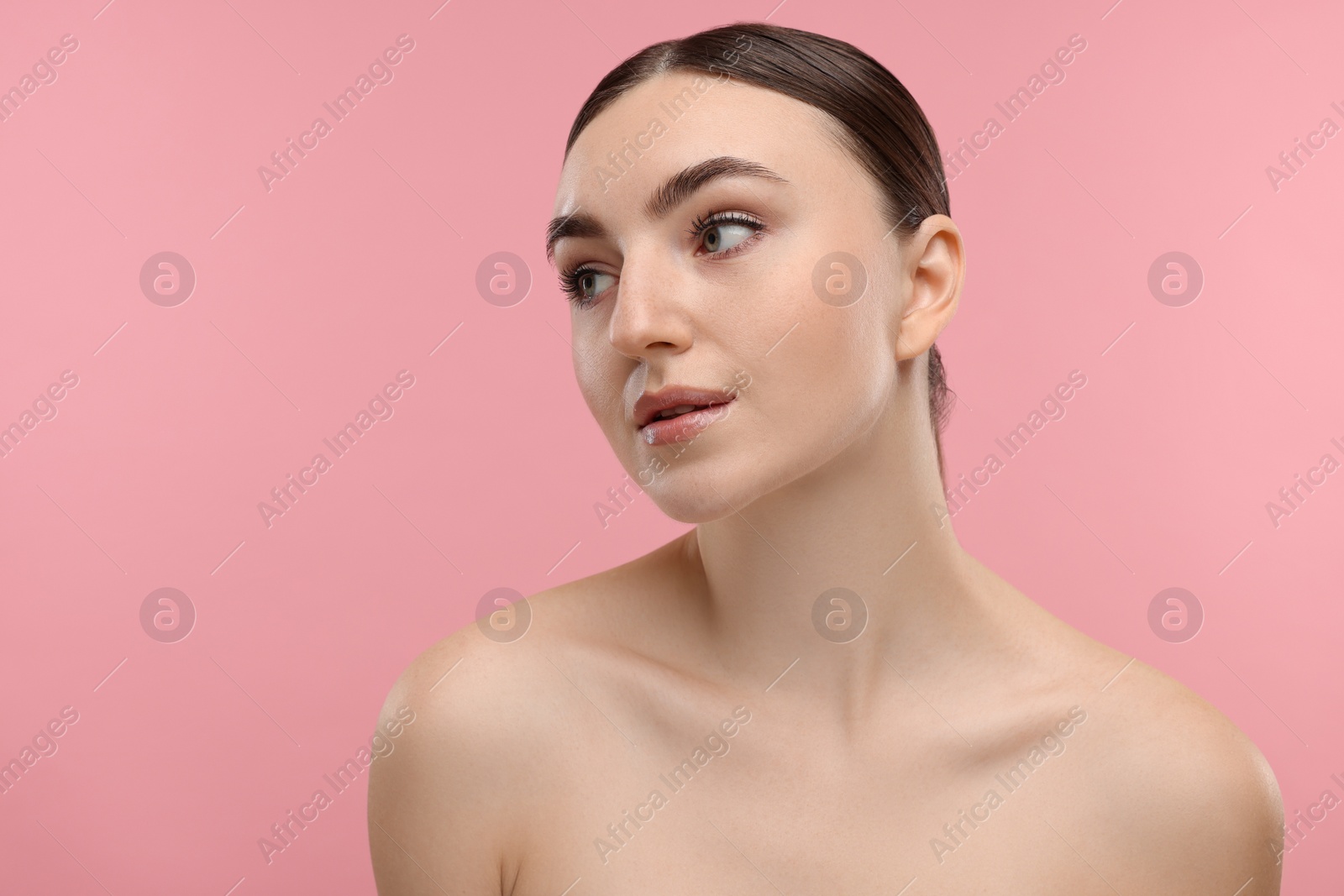 Photo of Portrait of beautiful woman on pink background. Space for text