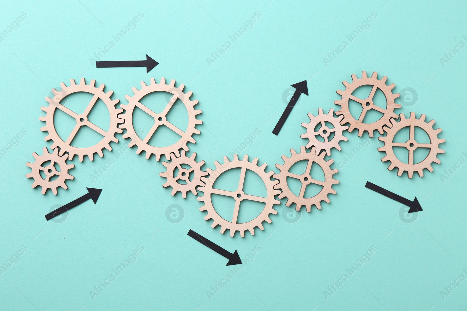 Photo of Business process organization and optimization. Scheme with wooden figures and arrows on light blue background, top view