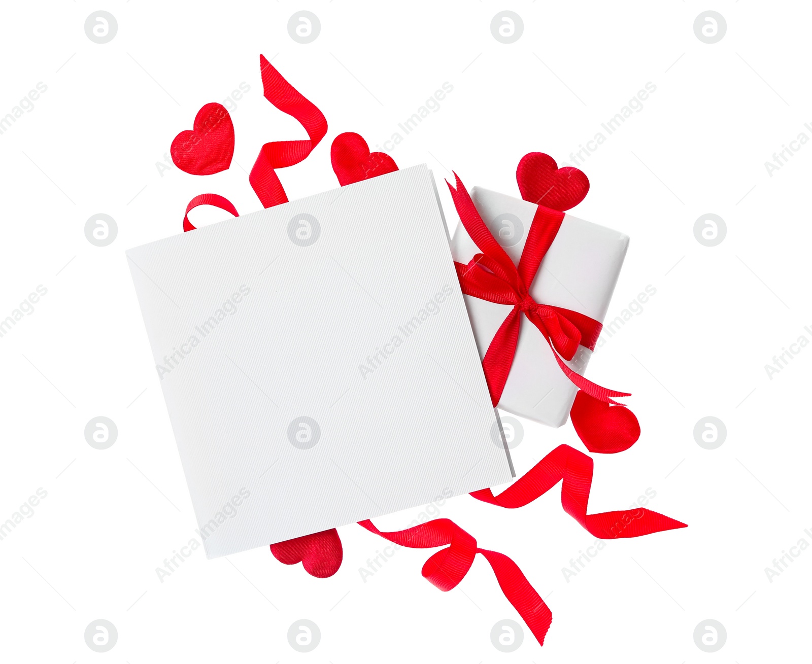 Photo of Blank card, gift box and red decorative hearts on white background, top view. Valentine's Day celebration